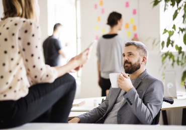 business-people-with-wheelchair-in-the-office-P9M4RX3